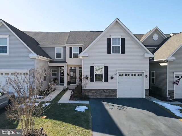 front of property with a garage and a front lawn