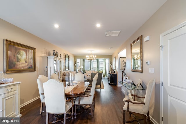 dining space featuring dark hardwood / wood-style floors and a notable chandelier