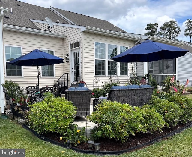 back of property featuring an outdoor living space