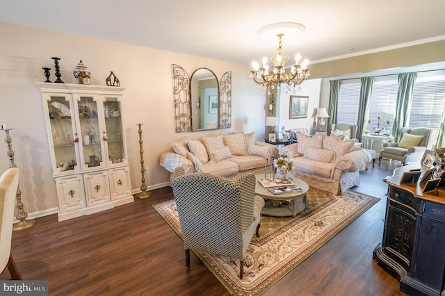 living room featuring crown molding, dark wood-type flooring, and a chandelier