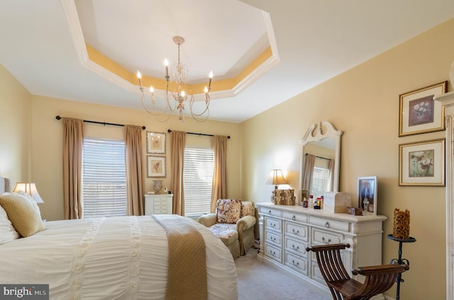 carpeted bedroom with an inviting chandelier and a raised ceiling