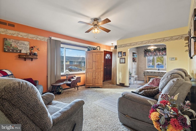 carpeted living room featuring ceiling fan