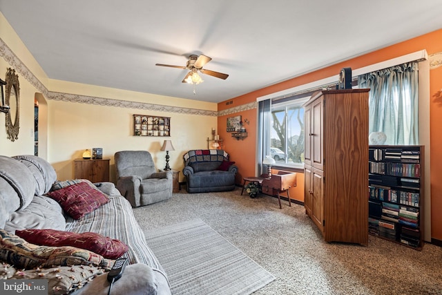 living room featuring ceiling fan and carpet