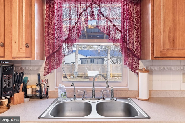 kitchen featuring sink and backsplash