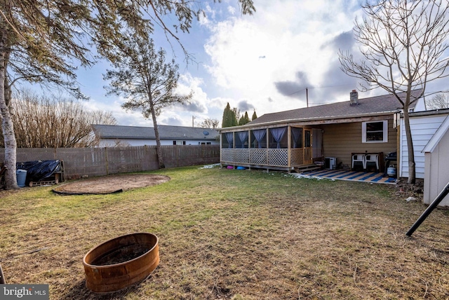 view of yard featuring an outdoor fire pit, a patio area, and a sunroom