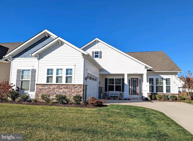 craftsman-style house featuring a garage and a front yard