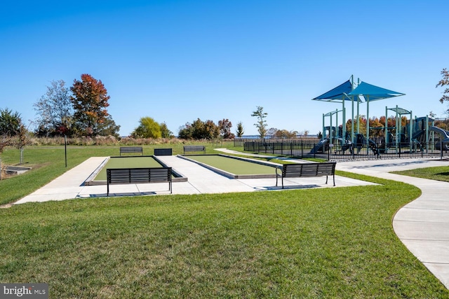 view of home's community featuring a playground and a lawn