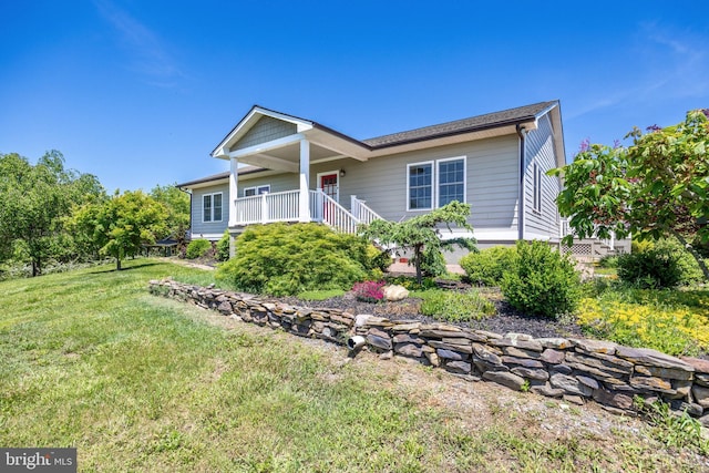 view of front of property with a front yard and covered porch