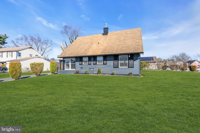 rear view of property with a yard