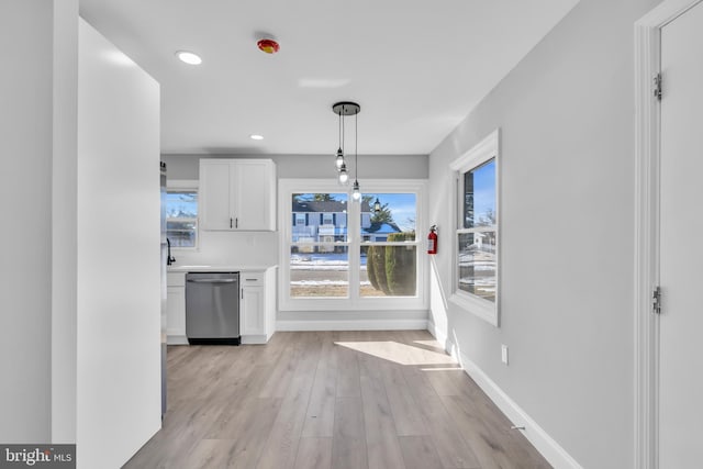 unfurnished dining area featuring light hardwood / wood-style flooring