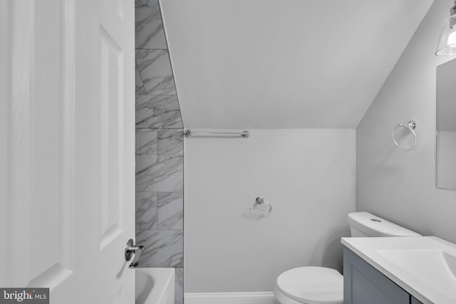 full bathroom with vanity, tiled shower / bath combo, lofted ceiling, and toilet