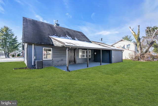 rear view of property featuring central AC unit, a patio area, and a lawn