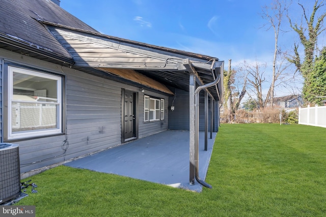 exterior space with a yard, a patio area, and central air condition unit