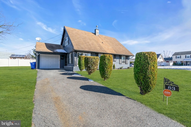 view of front facade featuring a garage and a front lawn