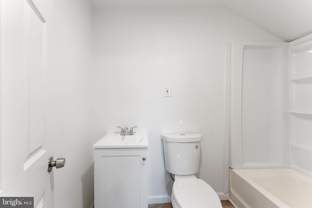 full bathroom featuring toilet, vanity, lofted ceiling, and shower / bathing tub combination