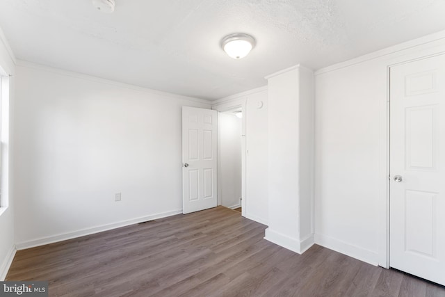 unfurnished bedroom featuring baseboards and wood finished floors