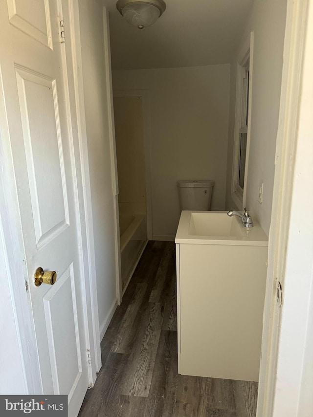 bathroom with vanity, a bathtub, wood-type flooring, and toilet