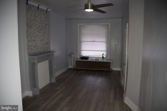 hallway featuring radiator heating unit and dark hardwood / wood-style floors