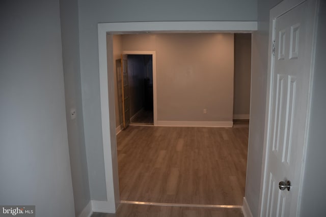 corridor featuring wood-type flooring