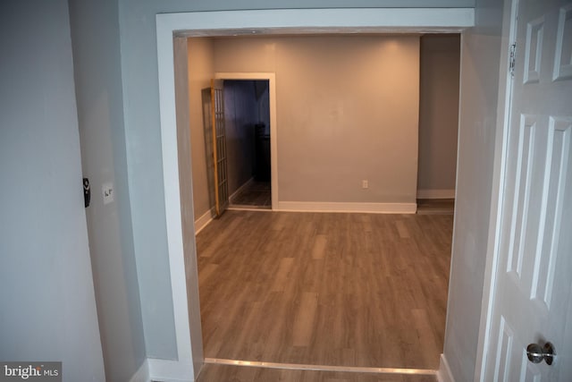 hall with hardwood / wood-style flooring