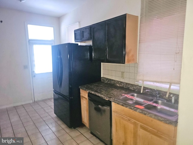 kitchen featuring light tile patterned flooring, sink, black refrigerator, dishwasher, and backsplash