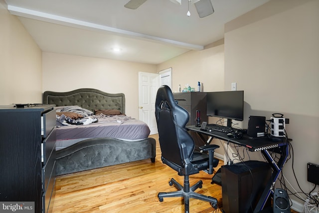 bedroom featuring ceiling fan, beam ceiling, and hardwood / wood-style floors