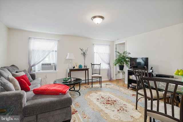 living room with cooling unit and baseboard heating