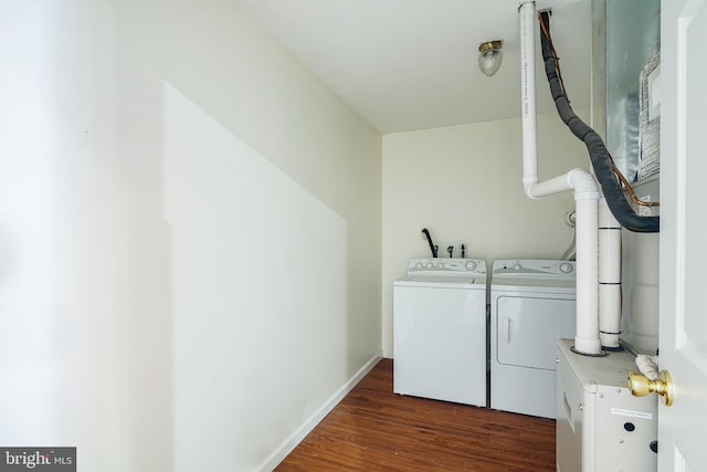 laundry room featuring dark wood-type flooring and washer and clothes dryer