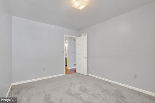 unfurnished room featuring carpet