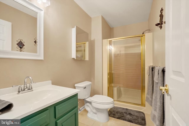 bathroom with vanity, toilet, tile patterned floors, and walk in shower