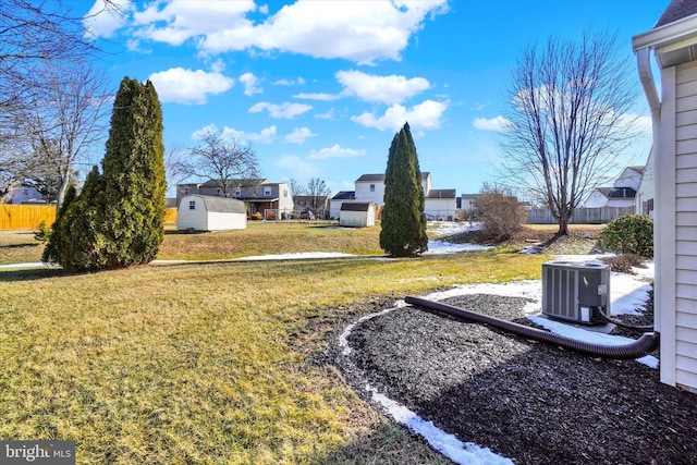 view of yard featuring central AC and a shed