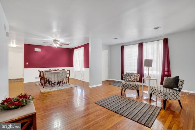 living room featuring ceiling fan and hardwood / wood-style floors