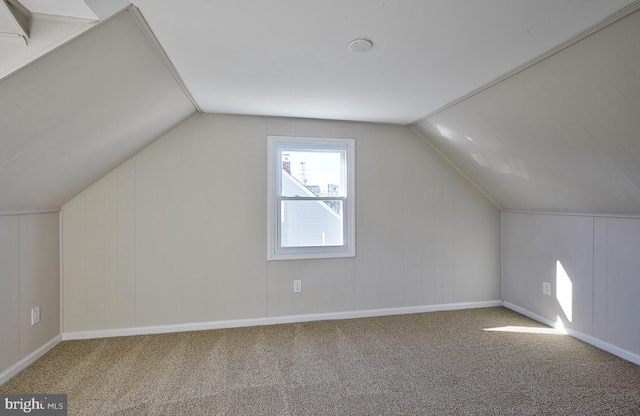 bonus room with lofted ceiling and carpet floors