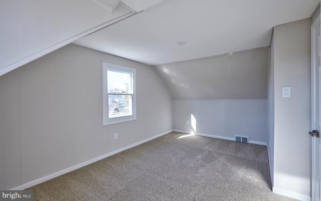 bonus room with lofted ceiling and carpet floors