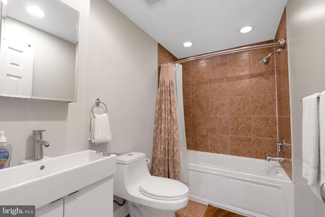 full bathroom with tile patterned flooring, sink, shower / tub combo with curtain, and toilet