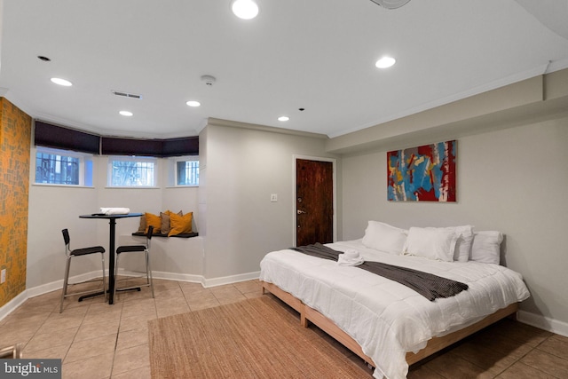 bedroom featuring light tile patterned floors and crown molding