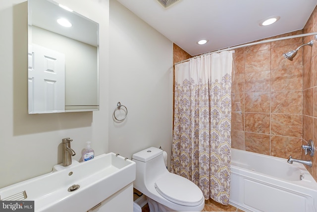 full bathroom with shower / bathtub combination with curtain, toilet, and sink