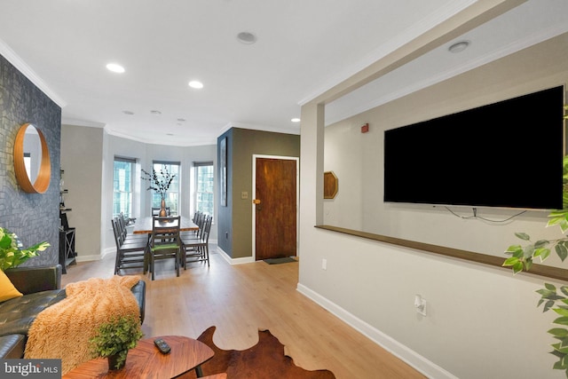 living room with crown molding and light wood-type flooring