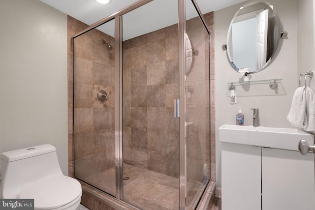 bathroom with walk in shower, vanity, and toilet