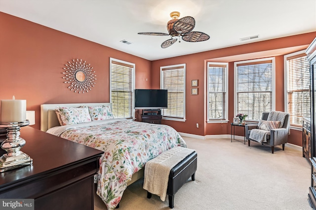 bedroom with ceiling fan and light colored carpet