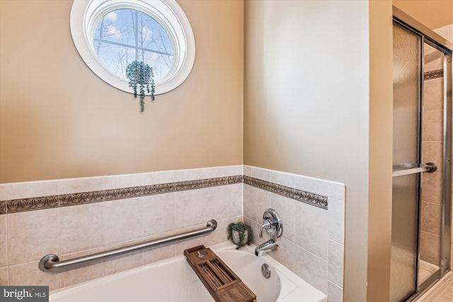 bathroom featuring separate shower and tub