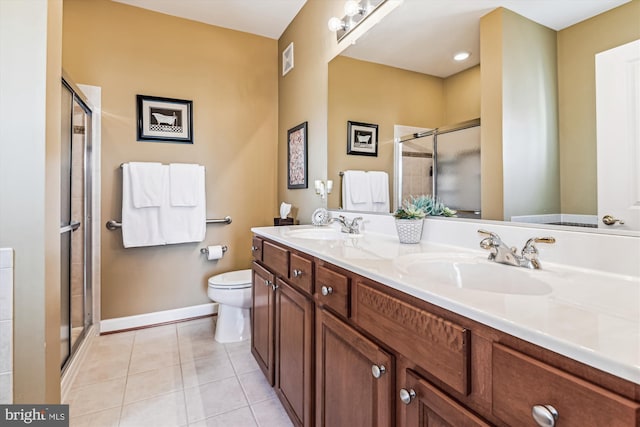 bathroom featuring tile patterned floors, toilet, an enclosed shower, and vanity