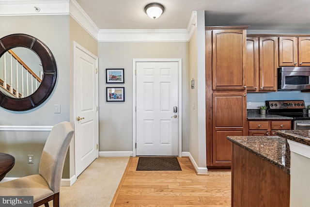 foyer featuring crown molding and light wood-type flooring