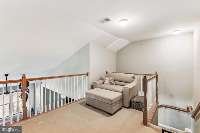 sitting room with lofted ceiling and light carpet