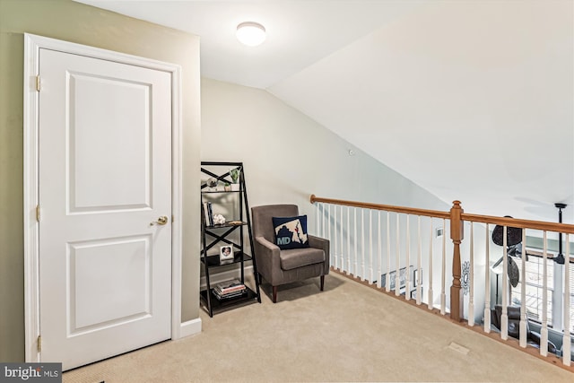 living area featuring vaulted ceiling and light carpet