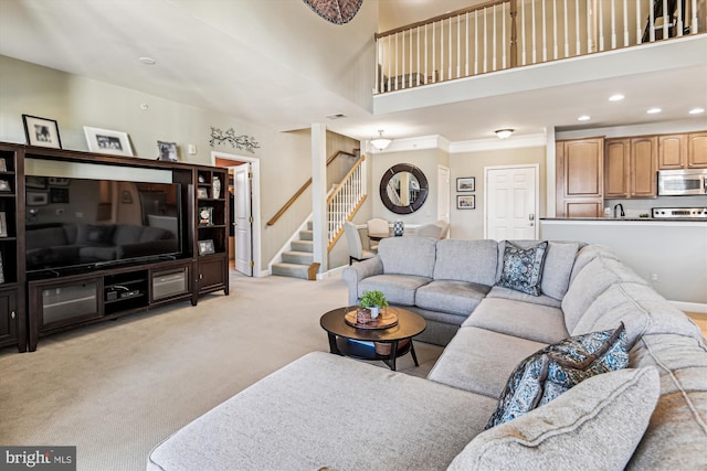 carpeted living room featuring a high ceiling