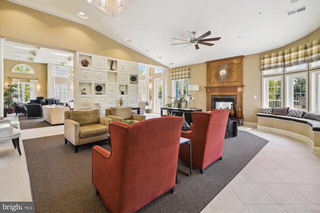 interior space with a wealth of natural light, high vaulted ceiling, a premium fireplace, and ceiling fan