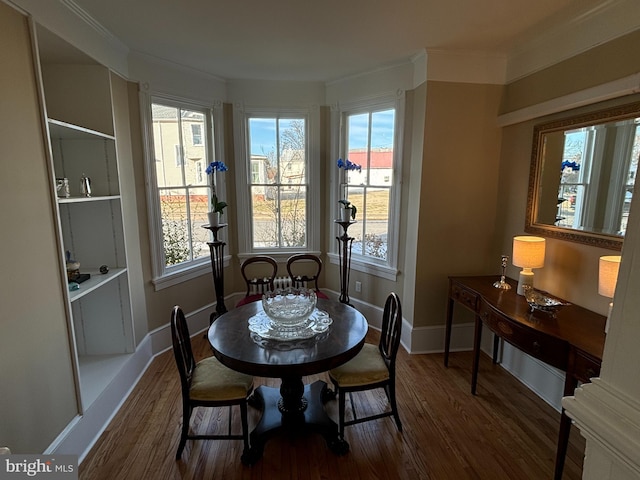 dining room featuring dark wood-type flooring and ornamental molding