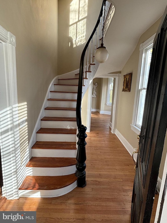 stairs with hardwood / wood-style floors