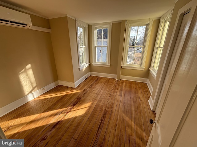 interior space with a wall mounted AC and light hardwood / wood-style floors